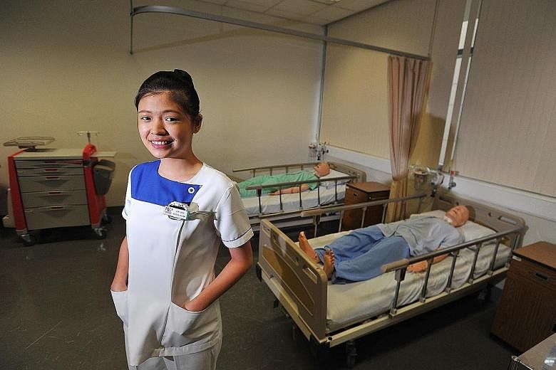 Ms Lim Ling in a simulated hospital ward at NYP, where she is studying nursing.
