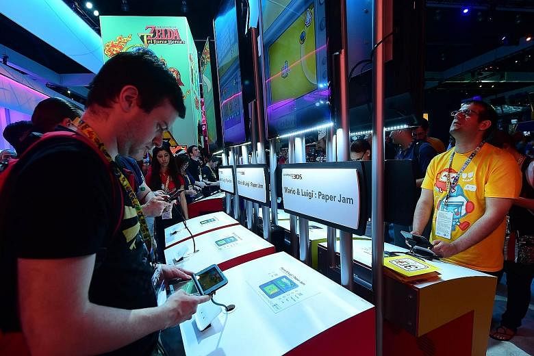 Fans playing on Nintendo 3DS at the Electronic Entertainment Expo in Los Angeles last month. At the DigiPen studios here, developers will be mentored and assisted to develop titles for the 3DS platform.
