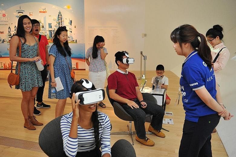Visitors using equipment to experience virtual reality at the Singapore STories: Then. Now. Tomorrow exhibition at the ArtScience Museum.