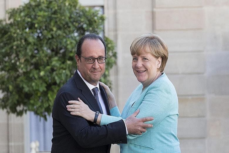 French President Francois Hollande meeting German Chancellor Angela Merkel in Paris earlier this month. Mr Hollande says Europe has let its institutions become weaker and that there should be a "government of the euro zone (with) a specific budget as