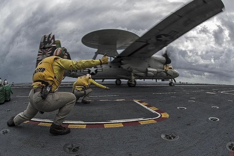 An E-2C Hawkeye plane taking off from the Nimitz-class aircraft carrier USS George Washington earlier this month during Exercise Talisman Sabre, held off the north coast of Australia.