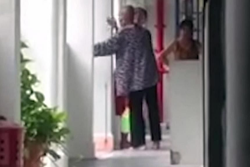 Stills from the video, which has gone viral on social media, showing the alleged abuse of a frail-looking woman by one of the two younger women watching her as she was sweeping the floor in the corridor outside a Housing Board unit in Lower Delta Roa