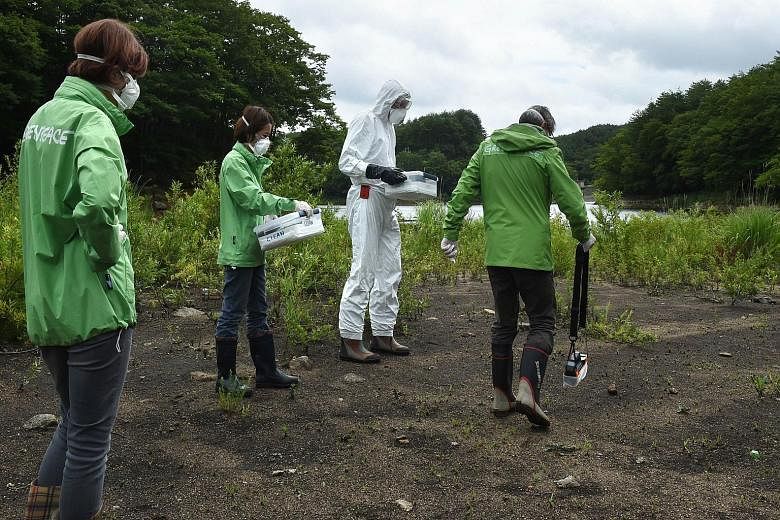 Greenpeace researchers checking radiation levels in Iitate. The government did not order its evacuation until more than a month after the accident, but post facto modelling of the toxic plume showed that the town was right in its path. 