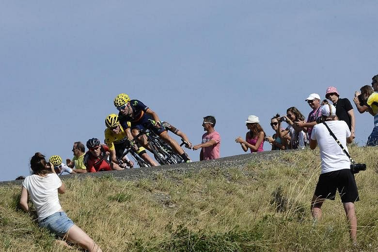 Chris Froome, wearing the overall leader's yellow jersey, in action during the 201km 16th stage of the Tour de France on Monday. He finished 28th, more than 18 minutes behind winner Ruben Plaza, but still had to answer doping-related questions.
