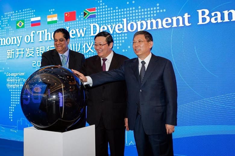 (From left) New Development Bank president Kundapur Vaman Kamath, China's Finance Minister Lou Jiwei and Shanghai's Mayor Yang Xiong at the opening ceremony of the NDB in Shanghai yesterday. 