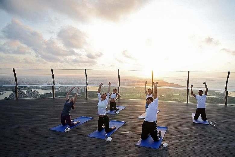 Simona Halep (second from left) is here to help launch this year's BNP Paribas WTA Finals Singapore. Yesterday, she participated in a sunrise yoga session at the Marina Bay Sands Observation Deck.