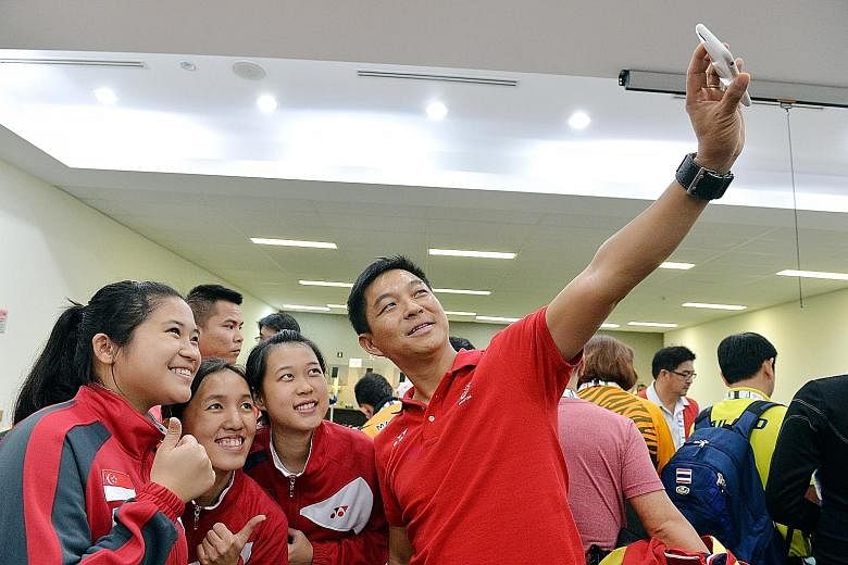 Mr Tan Chuan-Jin taking a wefie with Singapore's SEA Games 10m air rifle team gold medallists (from left) Martina Veloso, Jasmine Ser and Tessa Neo.