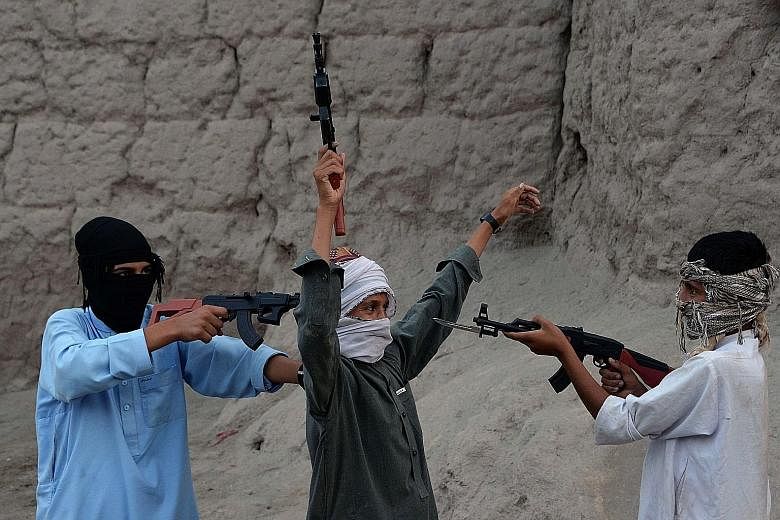 Afghan children playing with plastic guns as they celebrate the second day of Eid al-Fitr, which marks the end of the Muslim fasting month of Ramadan, on the outskirts of Jalalabad city in eastern Nangarhar province. Afghanistan banned the sale of im