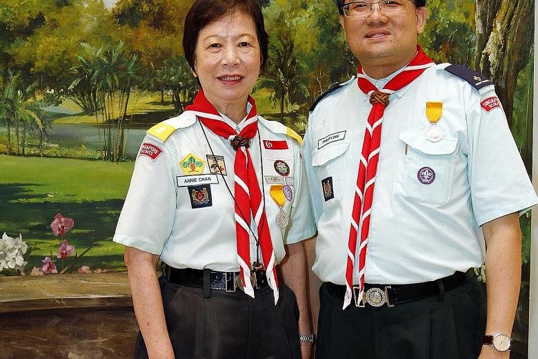 Teacher Annie Chan and auditor Philip Ling were among 35 adult scout leaders to receive Distinguished Service Awards at the Istana yesterday. The annual scout awards were handed out by President Tony Tan Keng Yam, who is also Chief Scout. Mrs Chan, 6