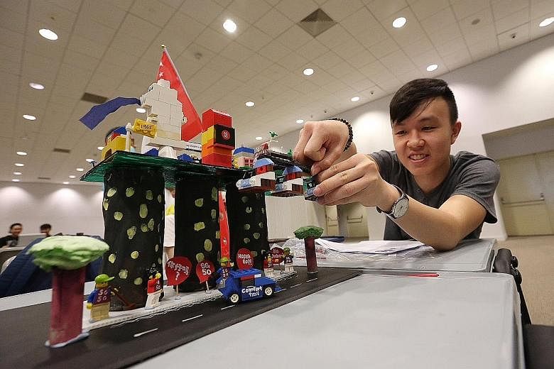 Mr Eugene Seow, 18, putting the finishing touches on a Lego structure representing his vision of Singapore, featuring cable cars as well as the towers of Marina Bay Sands. He was one of about 1,000 students from Republic Polytechnic who took part in 