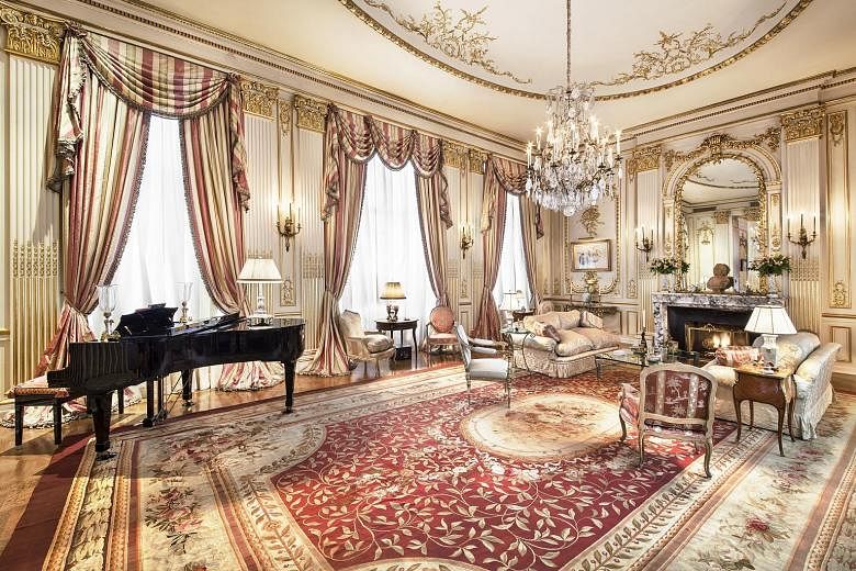 (From top) The formal dining room, the library and Rivers at home in a 2012 picture. The ballroom (right) in the triplex of Joan Rivers. The music room (above) has a high ceiling and gilded antique boiserie panelling.