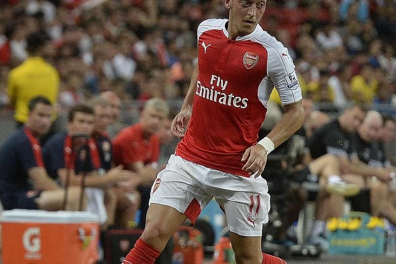 Arsenal's Mesut Oezil in action during the Barclays Asia Trophy final on July 18. His transfer fee in 2013 broke the club's record price.