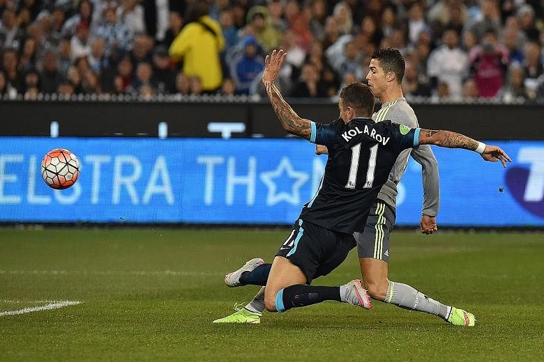 Real midfielder Cristiano Ronaldo shooting past City's Aleksandar Kolarov for his team's second goal in their 4-1 win in the International Champions Cup.