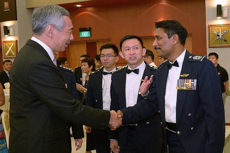 Prime Minister Lee Hsien Loong greeting Senior Warrant Officer Selvanathan Selvarajoo at last night's dinner.