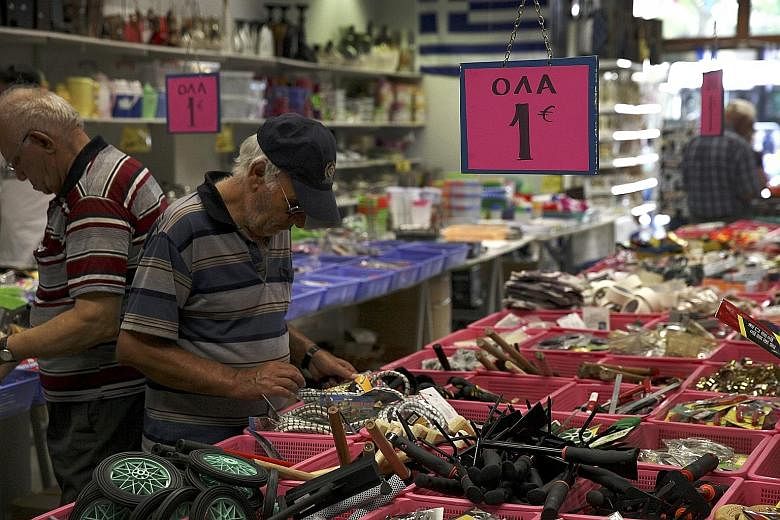 A man browsing inside a thrift shop in central Athens. Greece is seeking a three-year bailout worth up to €86 billion (S$128 billion) to avert a financial meltdown. The country had initially planned to go without fresh help from the IMF.