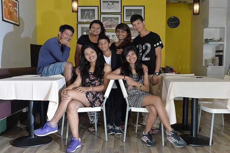 Kamilla Tasha Kummah (seated, right), 18, says she and her siblings are close to their half-brother and stepsisters. Pictured here are (clockwise from centre) her half-brother Tinohan Kummah, eight, stepsister Avril Sindhu, 19, brother Zackri Kummah,