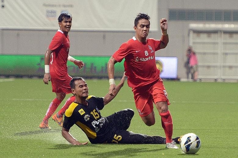 LionsXII's Hafiz Abu Sujad beating Perak's Mohd Idris Ahmad to the ball in their Malaysian Super League game. The Singapore team could be involved in the upcoming ASL.