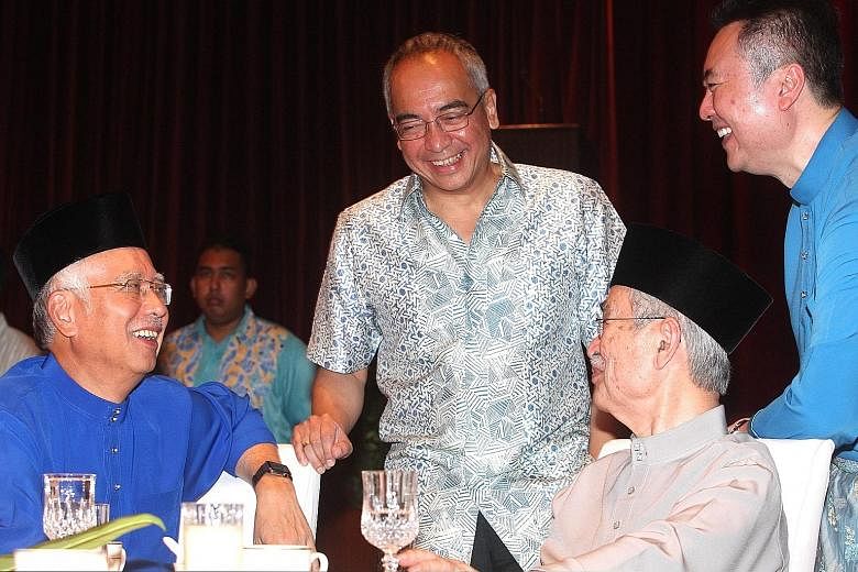 Prime Minister Najib Razak (far left) and former Malaysian leader Abdullah Ahmad Badawi sharing a light moment with Mr Nazir Razak (centre) and Tun Abdullah's son Kamaluddin Abdullah (left) during the former prime minister's Hari Raya open house in P