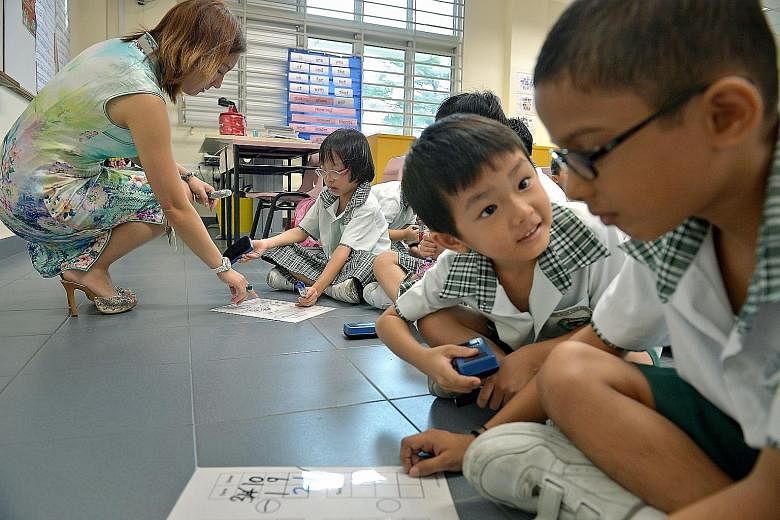 Teacher Valerie Tan conducting a maths lesson with a Primary 1 class in Northoaks Primary School. The school is one of three new primary schools that opened last year.