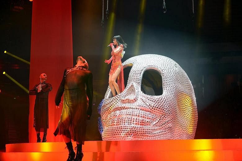 Jolin Tsai's concert proved a visual treat, with the superstar donning a Medusa headpiece (above) and having stage props such as a giant diamond- encrusted skull (left).