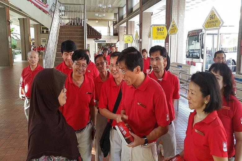 SDP secretary-general Chee Soon Juan (centre) leading party members and activists on a walkabout in Bukit Batok yesterday. The party is also contesting areas where it stood in the 2011 General Election.