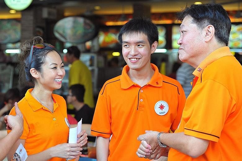 (From far left) Ms Kevryn Lim, 26, Mr Jan Chan, 25, and NSP president Sebastian Teo, 68, during a walkabout in Tampines West yesterday. NSP has contested in Tampines in every election except one, since 1988.