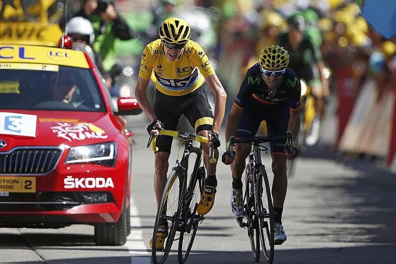 Team Sky rider Chris Froome, in the overall leader's yellow jersey, and Movistar rider Alejandro Valverde, sprinting to the finish line of the 110.5km 20th stage of the 102nd Tour de France from Modane to Alpe d'Huez in the French Alps. Froome says h