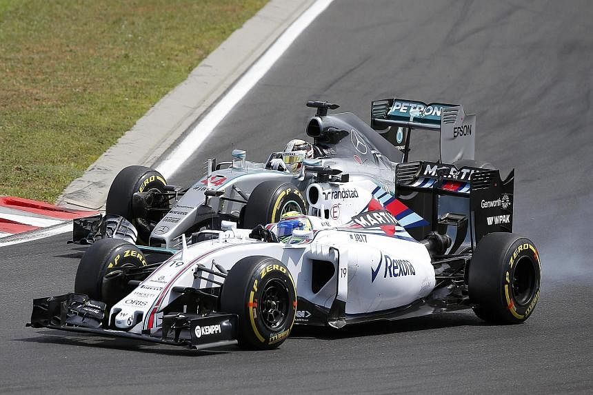 Mercedes' Lewis Hamilton (above) racing wheel-to-wheel with Williams' Felipe Massa. Hamilton, the reigning F1 world champion, admitted he made several bad decisions during the race.