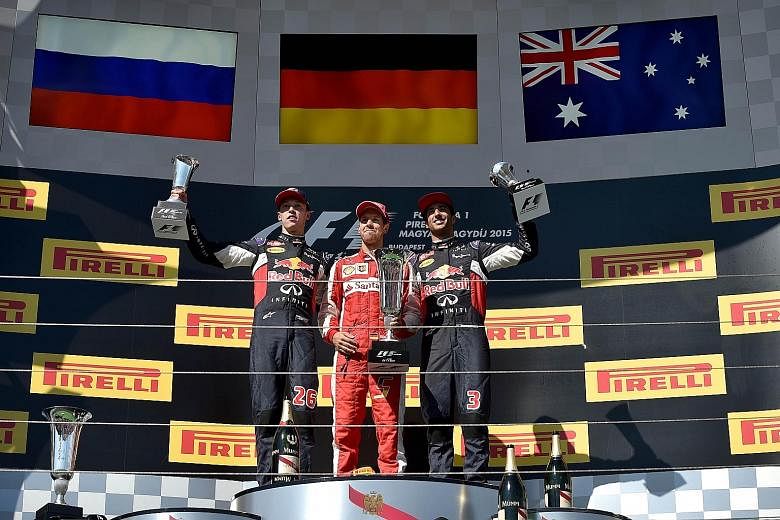 The post-race Hungarian Grand Prix winners' podium was notable for the absence of the dominant Mercedes drivers. Instead (from left) Red Bull's Daniil Kvyat (who finished second), winner Sebastian Vettel of Ferrari and Red Bull driver Daniel Ricciardo (th