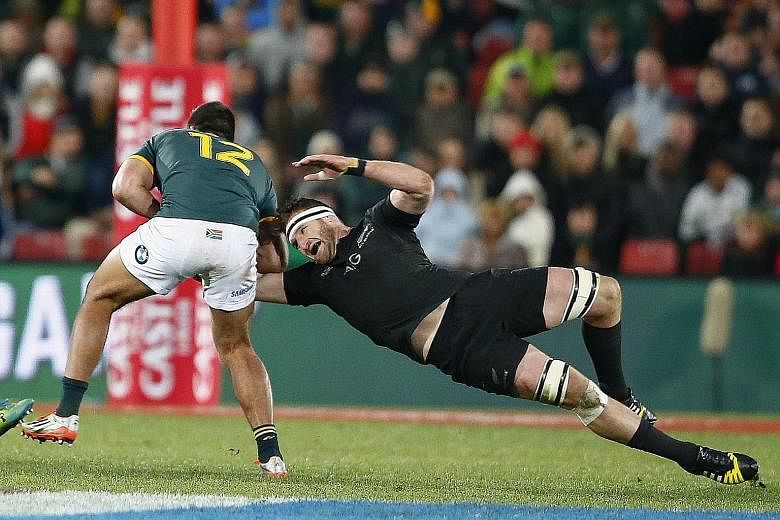Kieran Read (right) exemplifies the fighting spirit of the All Blacks who withstood an onslaught from the Springboks to post a 27-20 victory.