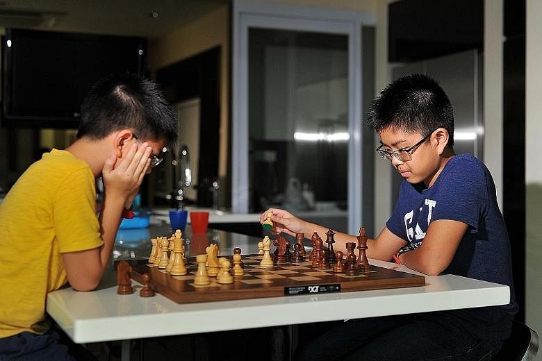 Cyrus Low (above), 13, is Singapore's top under-14 chess player, the ninth best in Asia and the 38th in the world in this age group. To show his commitment to the game, Cyrus gave most of his toys to his younger brother Darius (below, left), with who