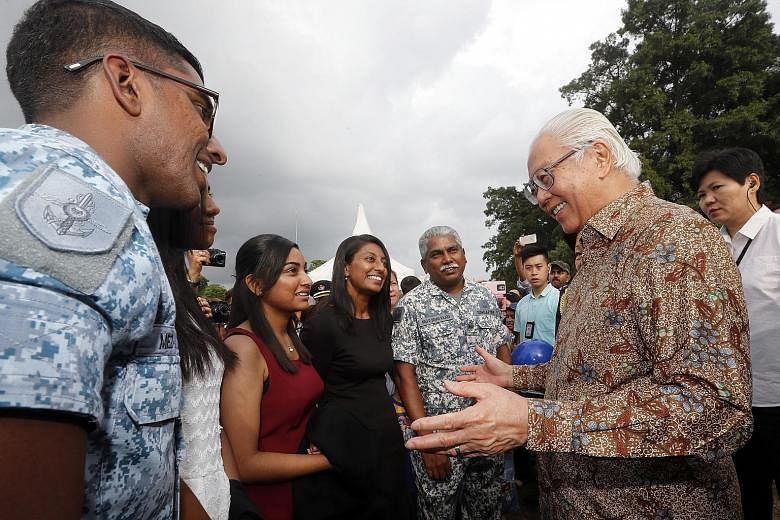 Military Expert (ME) 3 Brian Rajoo (centre) getting advice from President Tony Tan Keng Yam yesterday at an Istana exhibition to celebrate the 50th anniversary of the Singapore Armed Forces (SAF). The 52-year-old ME3 Rajoo was at the event with (from