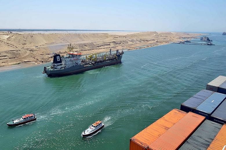 Vessels navigating the New Suez Canal in a test-run on Saturday. The waterway will be officially opened on Aug 6.