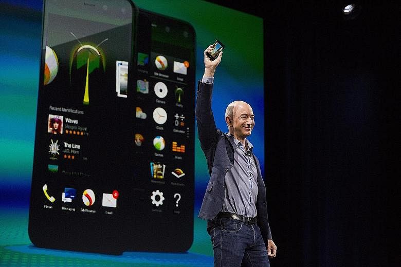 Amazon chief executive Jeff Bezos unveiling the Fire Phone in Seattle last year. For the week, Amazon shares rose 9.6 per cent.