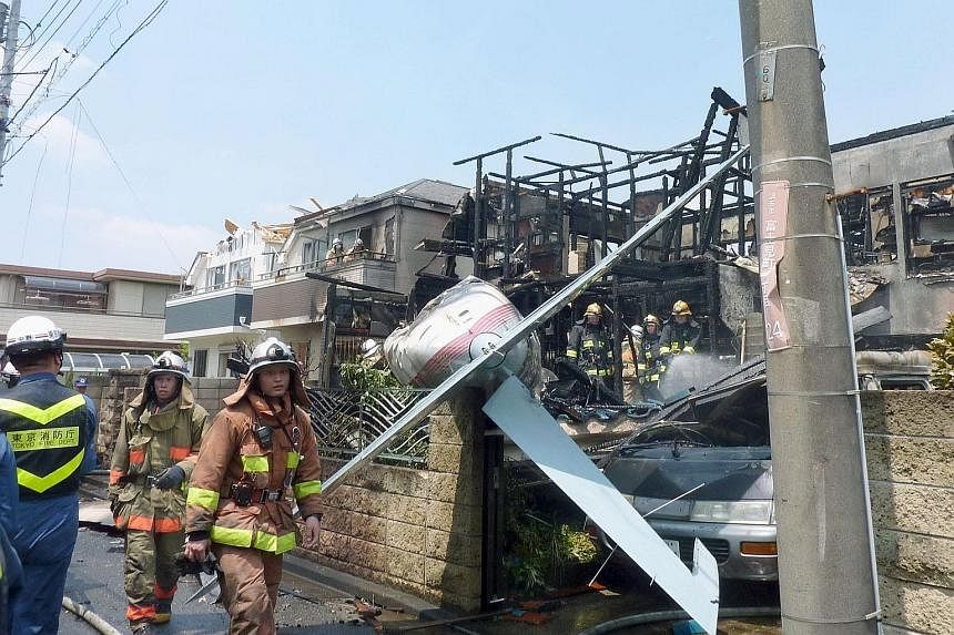 The small plane crashed in the residential district of Chofu, near a school, sports stadium and shopping plaza. Local media said its passengers may have been pilots-in-training.