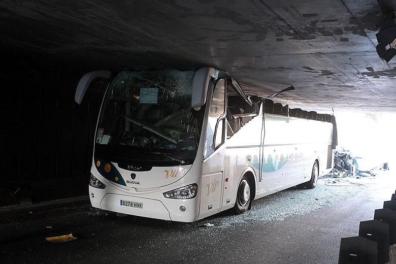 The wreckage of the bus after it crashed into a bridge in northern France on Sunday. The roof of the bus was ripped off.