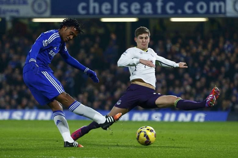 Everton defender John Stones (right), here defending against Chelsea winger Juan Cuadrado, is highly coveted by Blues boss Jose Mourinho. The Blues will reportedly make a renewed bid to sign the England international today.