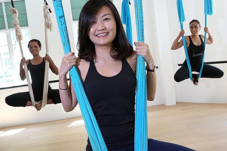 Ms Beh Hwee Sze (centre), 31, founder of fitness studio Upside Motion, with her staff, Ms Elly Selamat (left), 26, and Ms Mirna Liguori, 35. Upside Motion offers pilates, Xtend barre and the aerial programme. It conducts 100 classes a week in total a