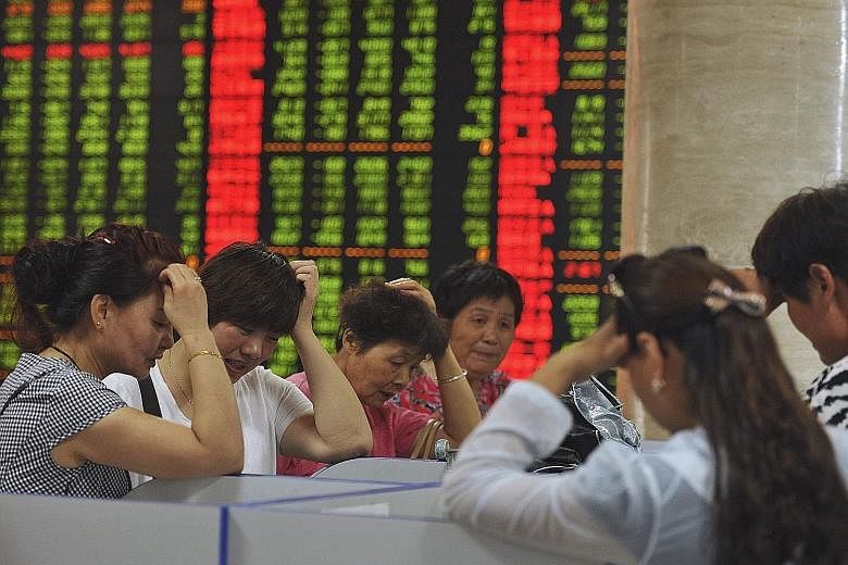 Investors at a brokerage house in Fuyang, in China's Anhui province, yesterday. Shanghai stocks have shed 11 per cent since last Friday and are down 29 per cent from their highest point this year.