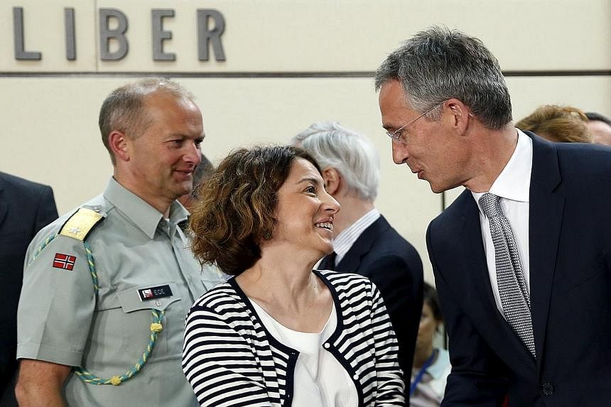 Nato Secretary-General Jens Stoltenberg greeting Ms Gulin Dinc, Turkey's Deputy Permanent Representative to Nato, at the emergency meeting of alliance members in Brussels yesterday.