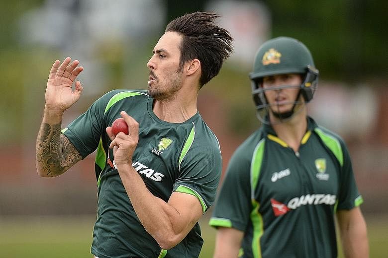 Australia's Mitchell Johnson bowling during a training session, watched by batsman Mitchell Marsh. The paceman took six wickets in the 405-run drubbing of the hosts in the second Test and his team are pleased with the way he is easing into the series