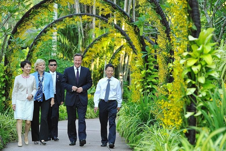 Mr David Cameron (centre) in the National Orchid Garden yesterday with (from left) Ms Grace Fu, Minister in the Prime Minister's Office; Britain's Minister for Small Business Anna Soubry; and Mr Kenneth Er, CEO of National Parks Board. The British le