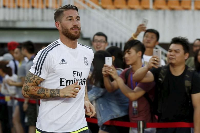 Sergio Ramos training at Tianhe Stadium in Guangzhou, China during Real's pre-season tour. The defender is now likely to　ink a new contract and remain at the Spanish giants, after two bids from United were rejected. 