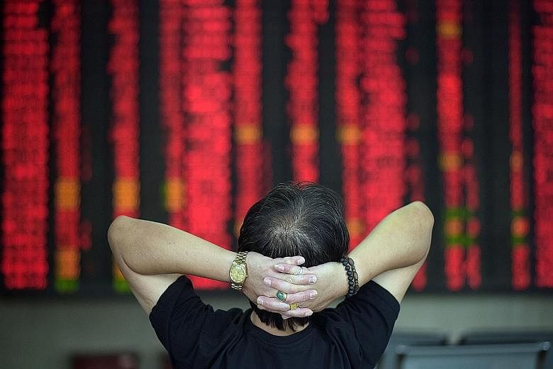 An investor observing market movements at a brokerage house in Shanghai yesterday. The waning interest in equities among China's 90 million retail investors underscores the challenge of supporting a market where individuals account for more than 80 p