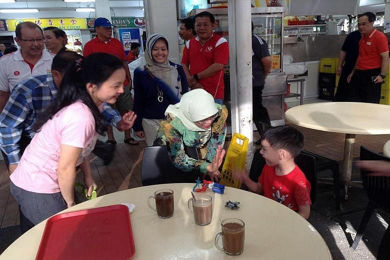 Jurong GRC MP Halimah Yacob meeting residents in Bukit Batok East, along with Ms Rahayu Mahzam (behind her).