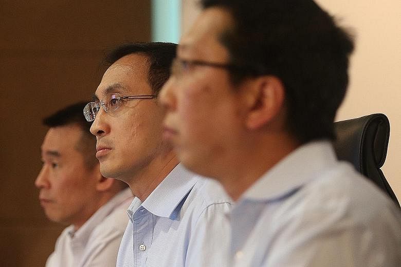 From far left: SMRT's managing director, trains, Mr Lee Ling Wee; SMRT's group CEO, Mr Desmond Kuek; and LTA's CEO, Mr Chew Men Leong at a media briefing last night to release the findings on the major rail breakdown on July 7. Commuters stranded at 