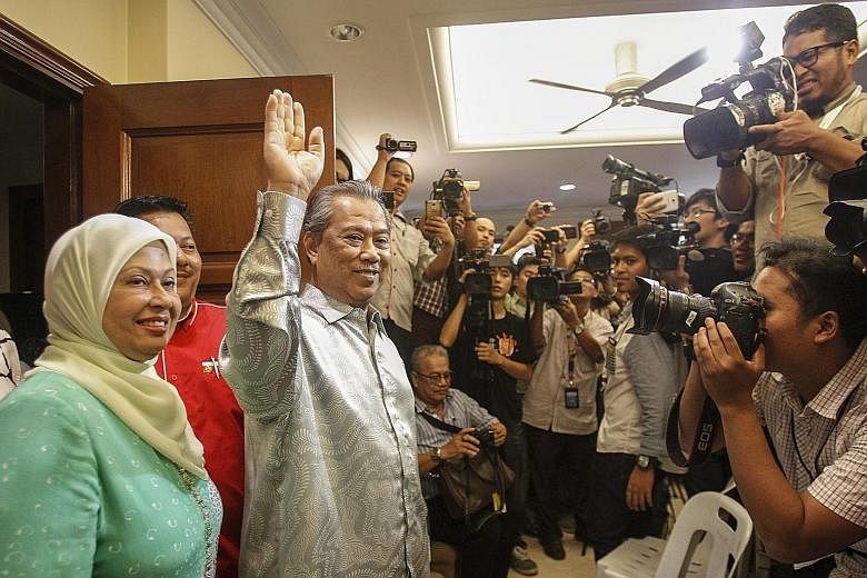 Mr Muhyiddin Yassin, seen here with his wife Noraini Abdul Rahman, at a press conference at his home in Bukit Damansara yesterday. He urged his supporters not to cause trouble for the country even though they were upset that he had been sacked as dep