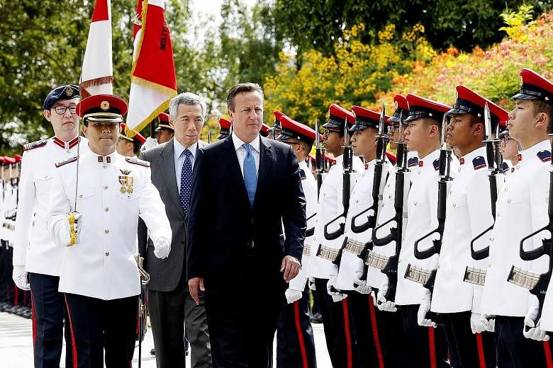 British PM David Cameron and Singapore PM Lee Hsien Loong at a welcome ceremony at the Istana yesterday. Britain plans to develop the north of England, and wants Singapore and South-east Asia to invest.