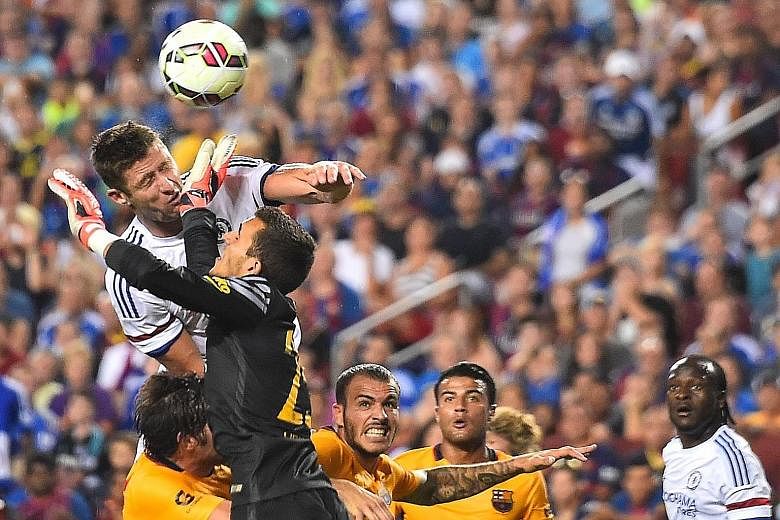 Gary Cahill heading past Barcelona goalkeeper Jordi Masip to equalise for Chelsea, suffering a suspected broken nose in the process. He and Diego Costa, who has a slight hamstring strain, may miss Sunday's Community Shield.