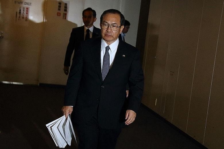 Mr Masashi Muromachi arriving for a meeting with a revitalisation committee at Toshiba's Tokyo headquarters yesterday.